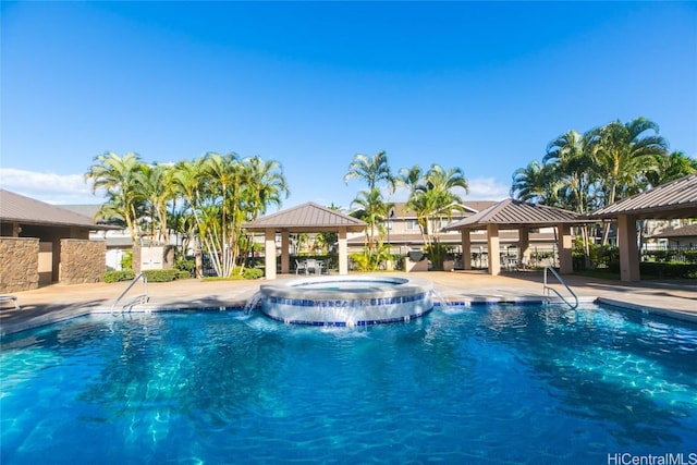 pool with a hot tub and a gazebo