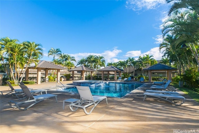 view of pool featuring a patio area, a pool with connected hot tub, and a gazebo