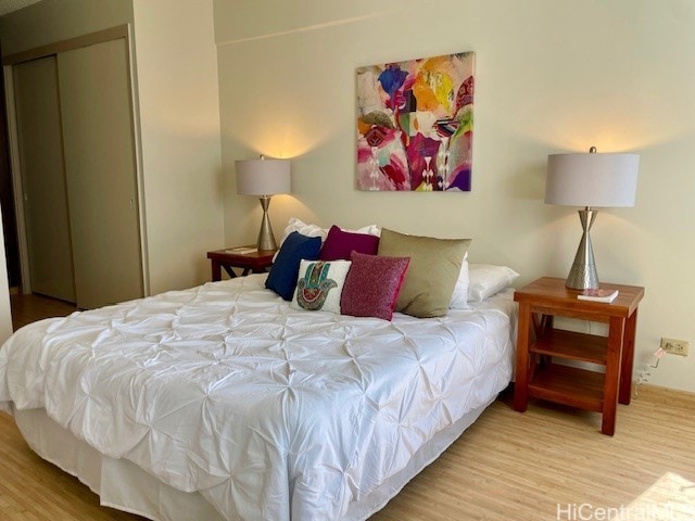 bedroom featuring a closet and wood finished floors