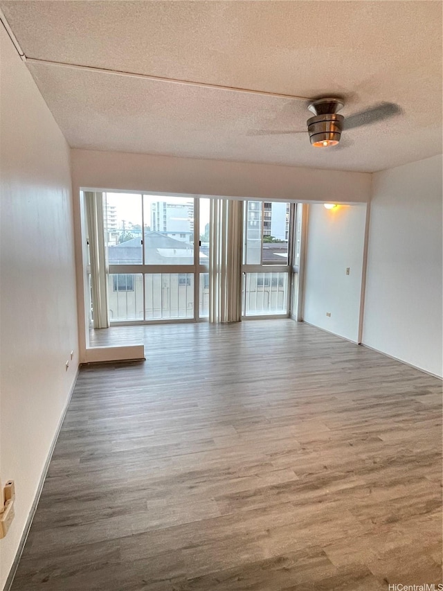 1710 Punahou St Unit 305, Honolulu, HI 96822 - unfurnished room with a textured ceiling and wood finished floors