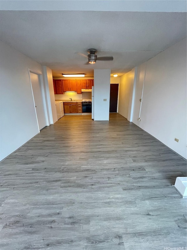 1710 Punahou St Unit 305, Honolulu, HI 96822 - unfurnished living room featuring wood finished floors, a ceiling fan, and a sink