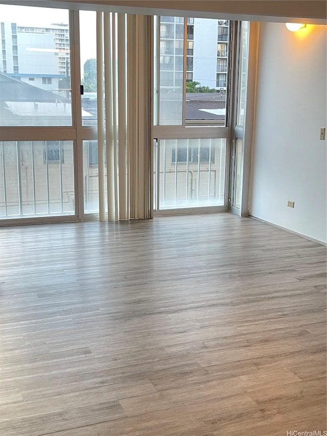 1710 Punahou St Unit 305, Honolulu, HI 96822 - empty room with healthy amount of natural light and wood finished floors