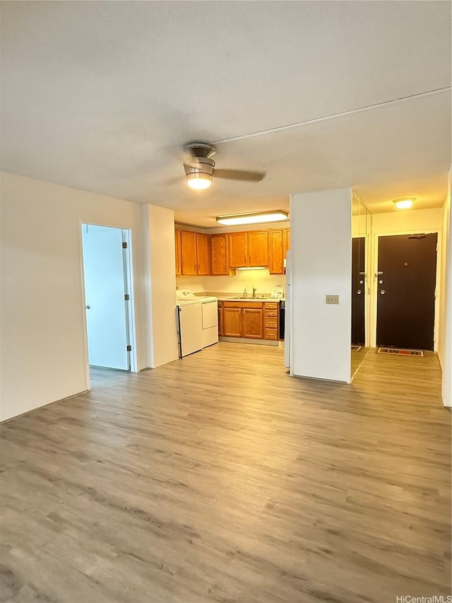 1710 Punahou St Unit 305, Honolulu, HI 96822 - kitchen with washer and dryer, open floor plan, brown cabinets, and light wood finished floors