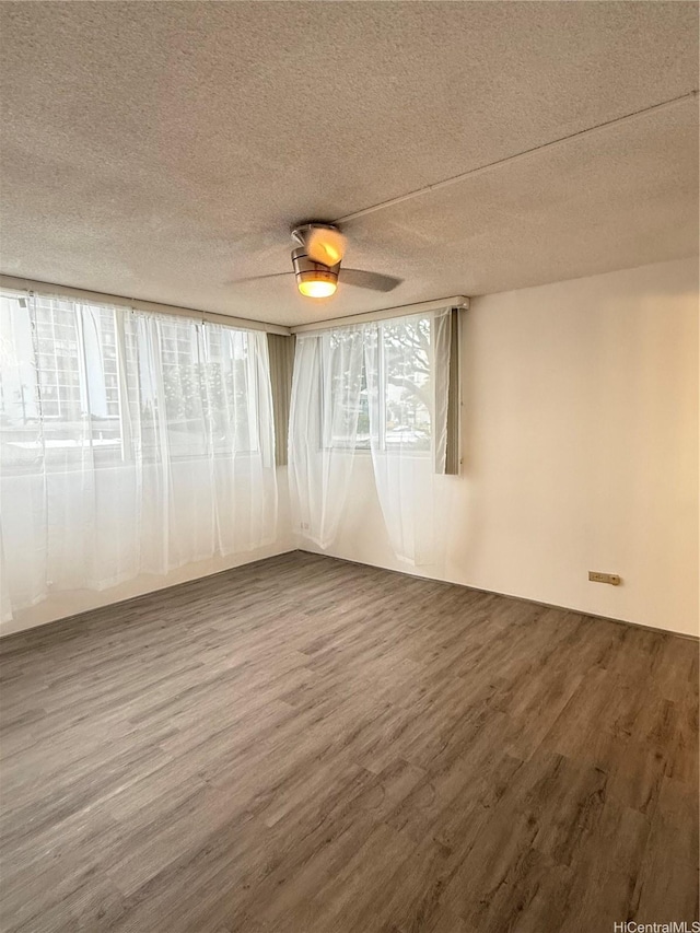 1710 Punahou St Unit 305, Honolulu, HI 96822 - spare room featuring dark wood-type flooring, a textured ceiling, and a ceiling fan