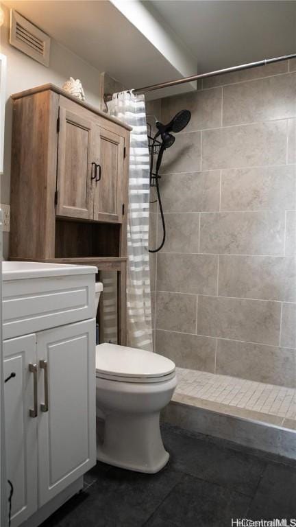 full bath featuring vanity, visible vents, a tile shower, tile patterned flooring, and toilet