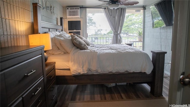 bedroom with access to outside, a wall mounted AC, and wood finished floors