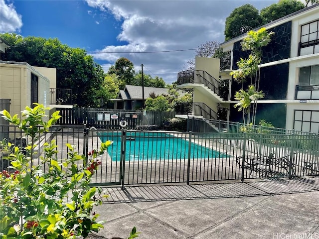 community pool featuring a patio and fence