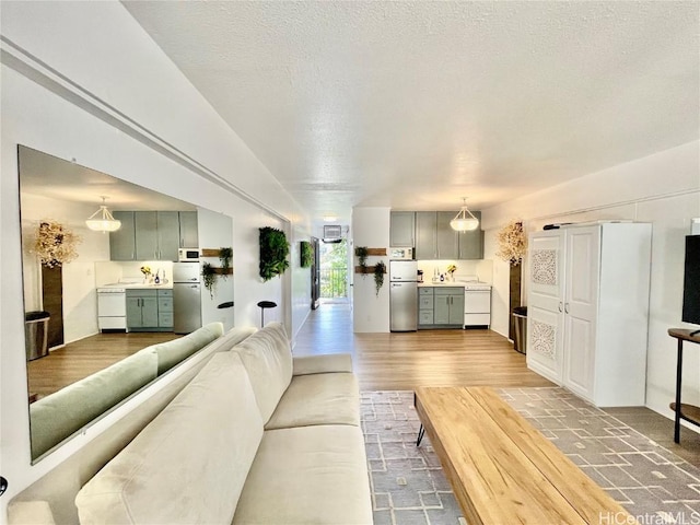 living area with wood finished floors and a textured ceiling