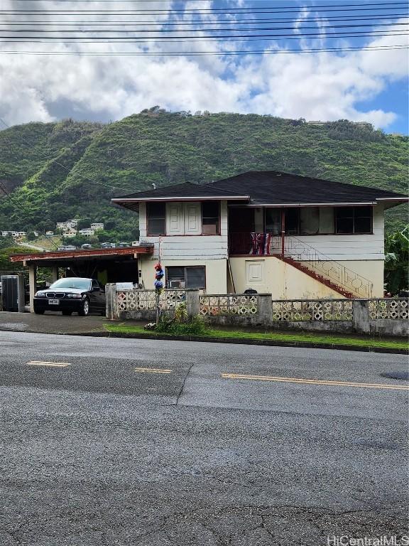 view of front of property featuring a mountain view and fence