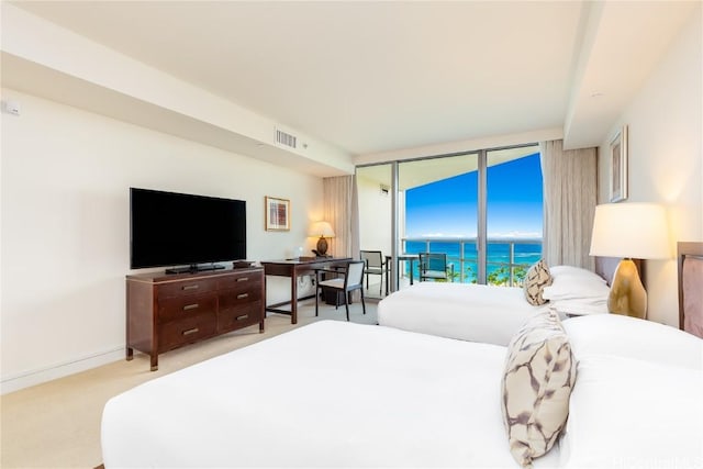 bedroom with access to exterior, light colored carpet, floor to ceiling windows, and visible vents