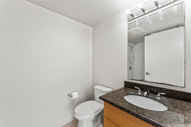 full bath featuring toilet, vanity, tile patterned flooring, baseboards, and walk in shower