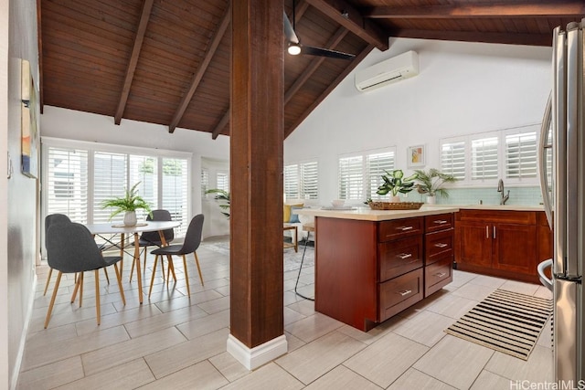 kitchen featuring wooden ceiling, a sink, beam ceiling, freestanding refrigerator, and a wall mounted air conditioner