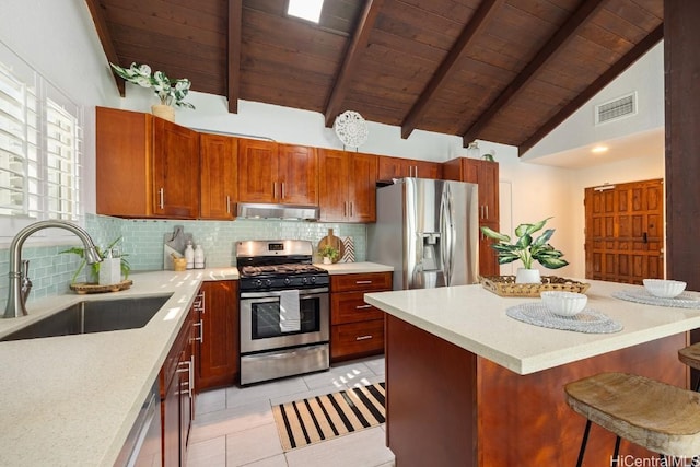 kitchen with a breakfast bar, tasteful backsplash, visible vents, appliances with stainless steel finishes, and a sink