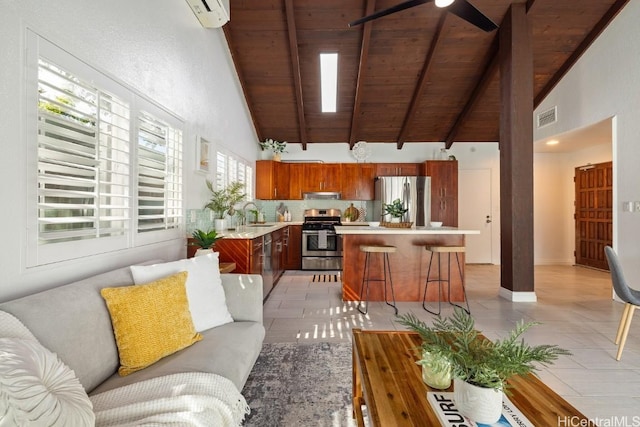 kitchen featuring visible vents, a kitchen island, appliances with stainless steel finishes, light countertops, and light tile patterned flooring