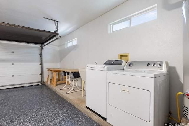 laundry room featuring a garage, washer and dryer, and laundry area