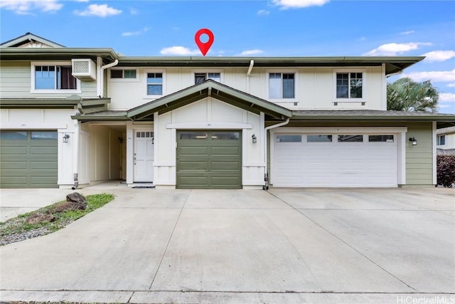 view of property featuring an attached garage, driveway, and board and batten siding