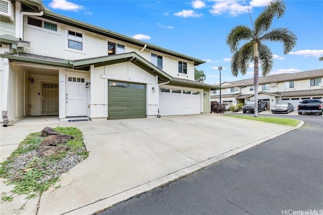 townhome / multi-family property featuring board and batten siding, concrete driveway, and an attached garage