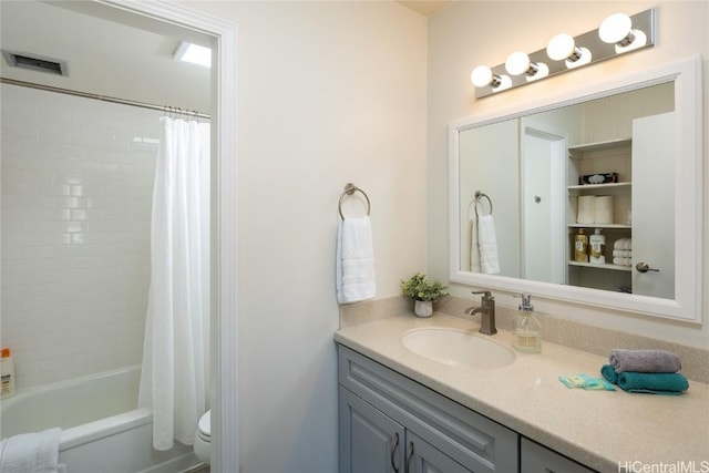 bathroom with shower / bath combo with shower curtain, vanity, and toilet