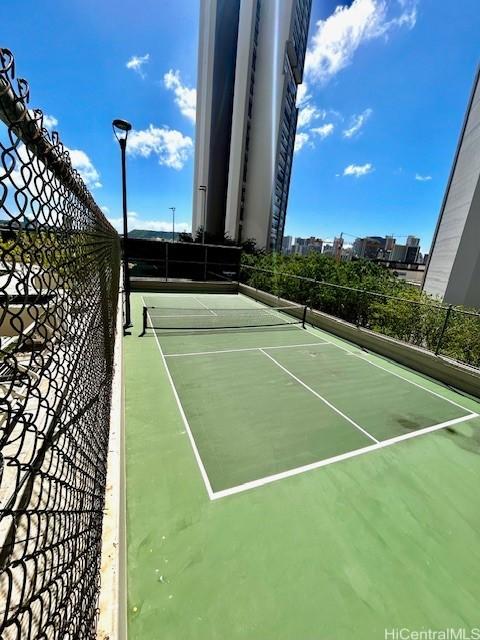 view of tennis court with fence