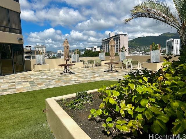 view of home's community with a mountain view and a patio