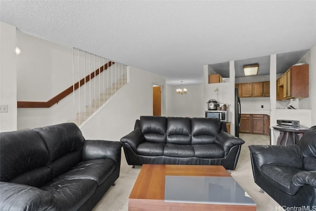 living room with a textured ceiling, stairs, a notable chandelier, and light colored carpet