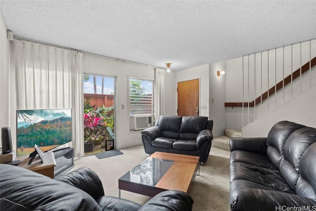 carpeted living room featuring cooling unit, a textured ceiling, and stairs