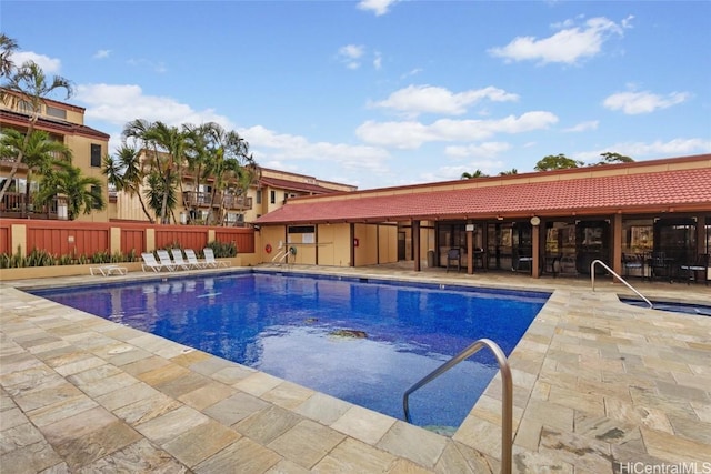 pool featuring a patio area and fence