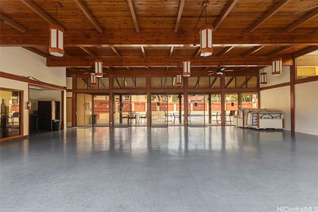 garage with wood ceiling, a ceiling fan, and freestanding refrigerator