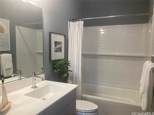 bathroom with vanity, shower / bath combo with shower curtain, and toilet