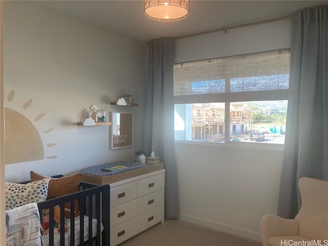 bedroom with a crib and baseboards