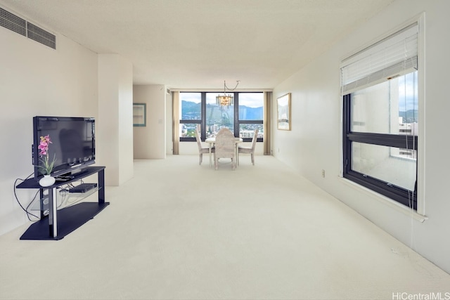 living area featuring carpet floors and visible vents