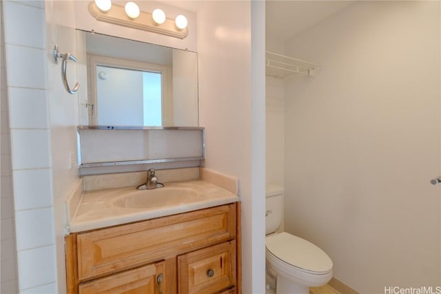 bathroom with toilet and vanity