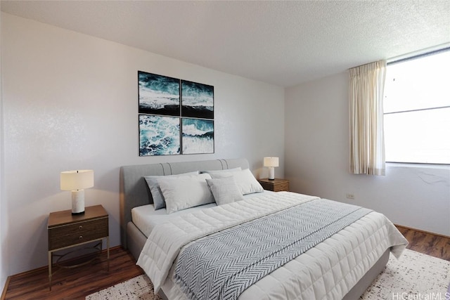 bedroom featuring a textured ceiling and wood finished floors