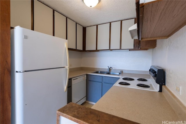 kitchen with white appliances, a sink, light countertops, under cabinet range hood, and a textured ceiling