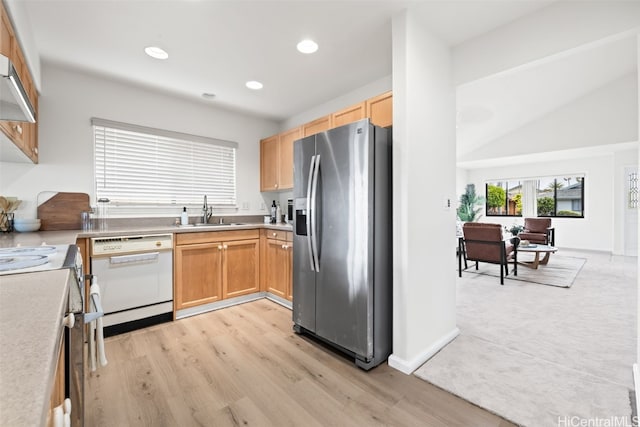 kitchen with recessed lighting, stainless steel fridge with ice dispenser, white dishwasher, a sink, and light countertops