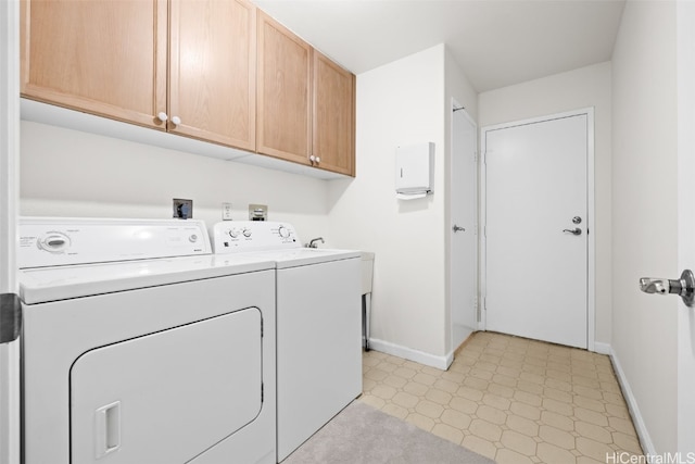 laundry area featuring baseboards, cabinet space, light floors, and independent washer and dryer