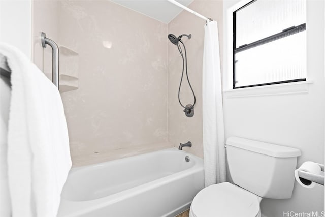 bathroom featuring toilet and shower / tub combo with curtain