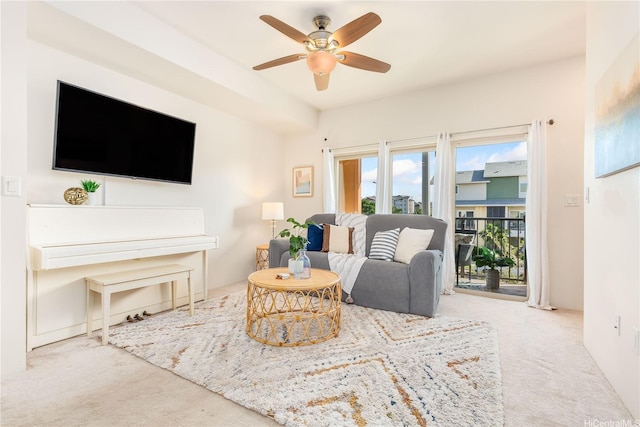 carpeted living room featuring a ceiling fan