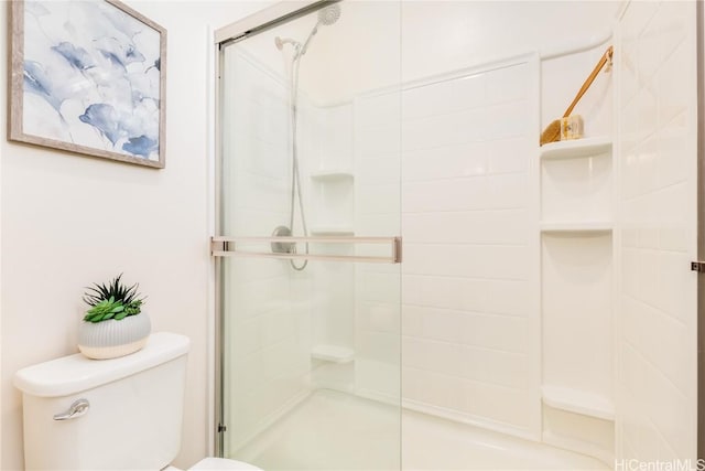 full bathroom with a shower stall and toilet