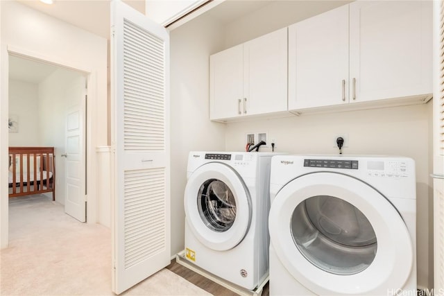 laundry area featuring cabinet space and washer and clothes dryer