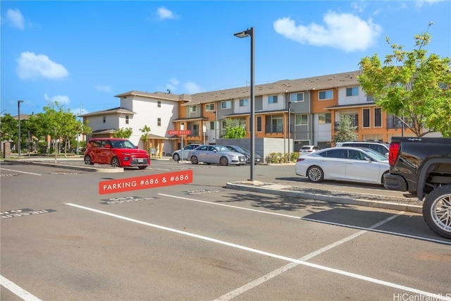 uncovered parking lot with a residential view