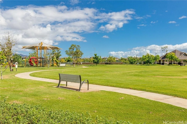 surrounding community with a yard and playground community