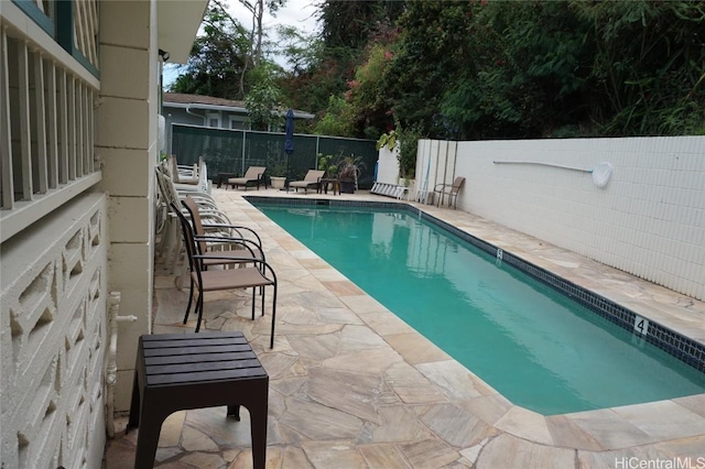 view of pool featuring a patio, a fenced in pool, and fence