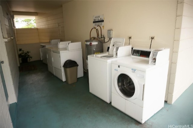 clothes washing area featuring washing machine and dryer and water heater