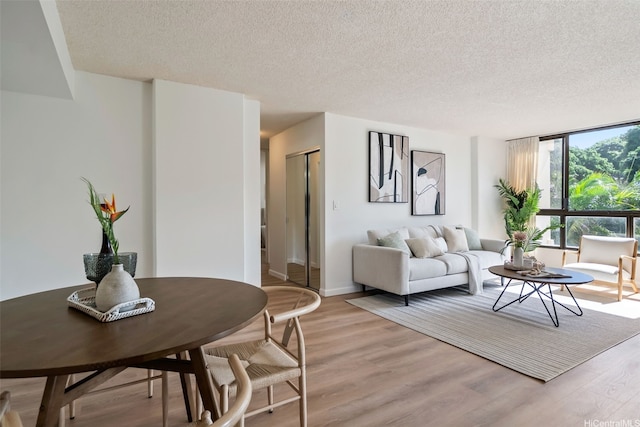 3138 Waialae Ave Unit 217, Honolulu, HI 96816 - living room with a textured ceiling, light wood-style floors, and baseboards