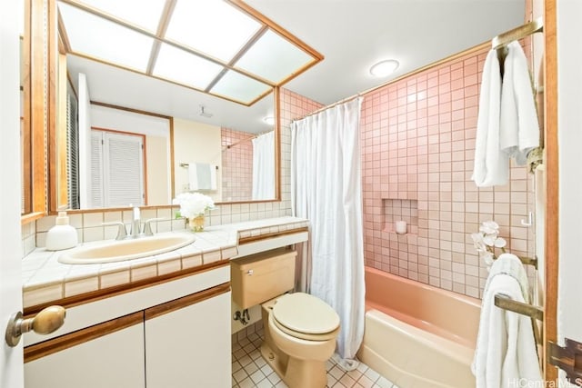 bathroom featuring vanity, shower / bathtub combination with curtain, tile patterned floors, toilet, and tile walls