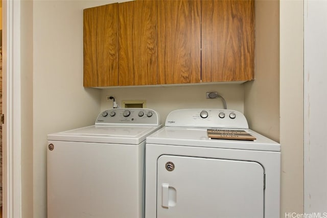 clothes washing area with cabinet space and separate washer and dryer