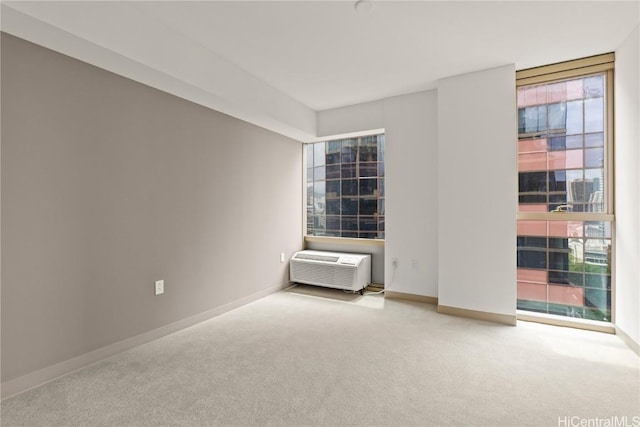 unfurnished room featuring a wealth of natural light, baseboards, and carpet floors