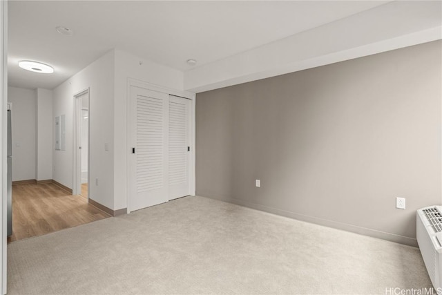 unfurnished bedroom featuring a closet, baseboards, and carpet flooring