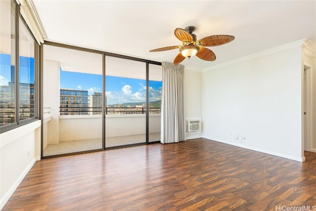 spare room with ceiling fan, wood finished floors, baseboards, and ornamental molding